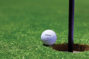 golf ball and hole with flag