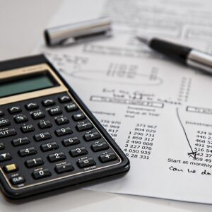 Calculator and pen on financial documents