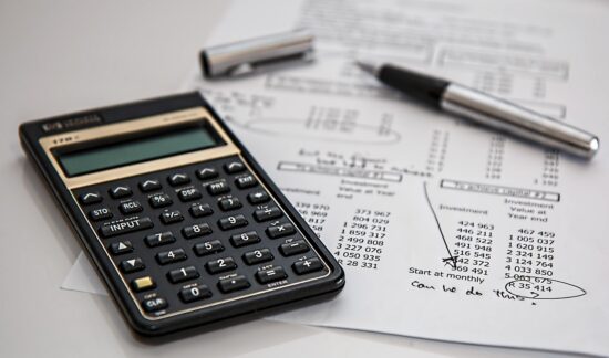 Calculator and pen on financial documents