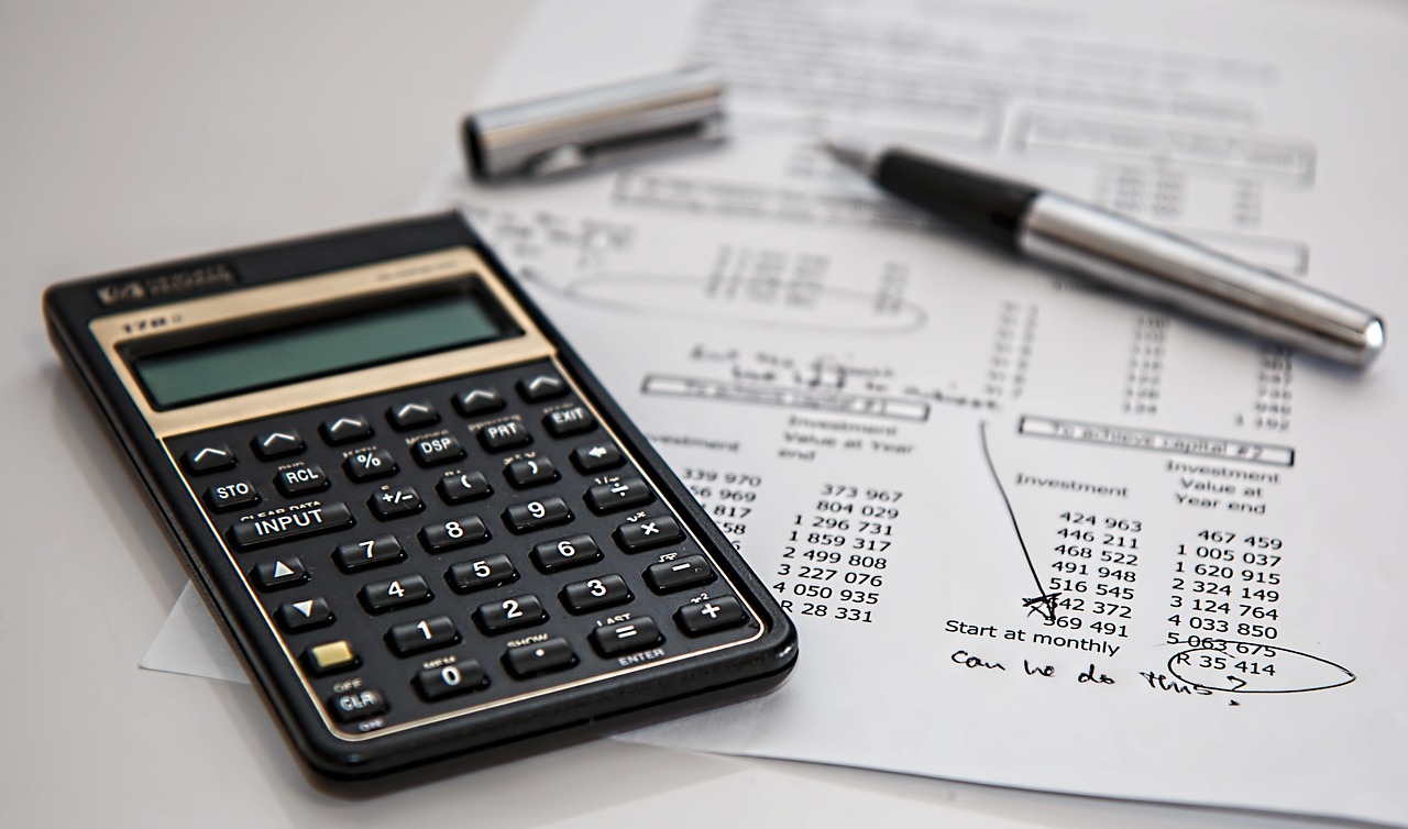 Calculator and pen on financial documents