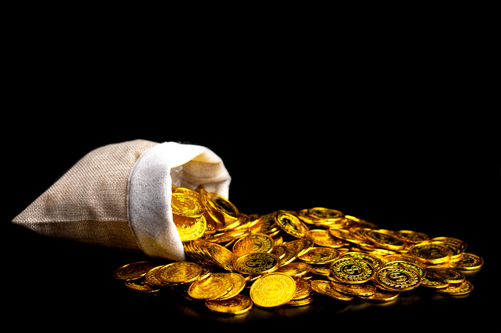 Stacked gold coins spilling from a treasure sack